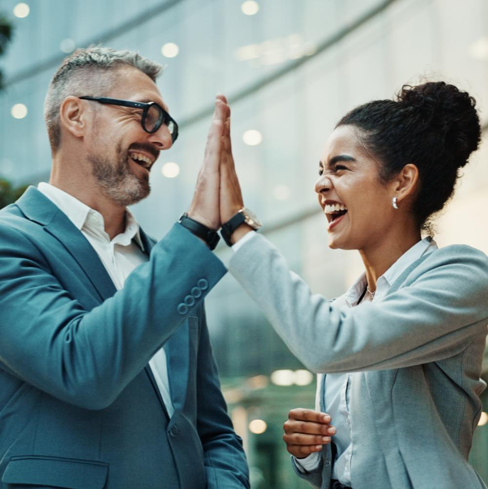 two working professionals doing a high-five